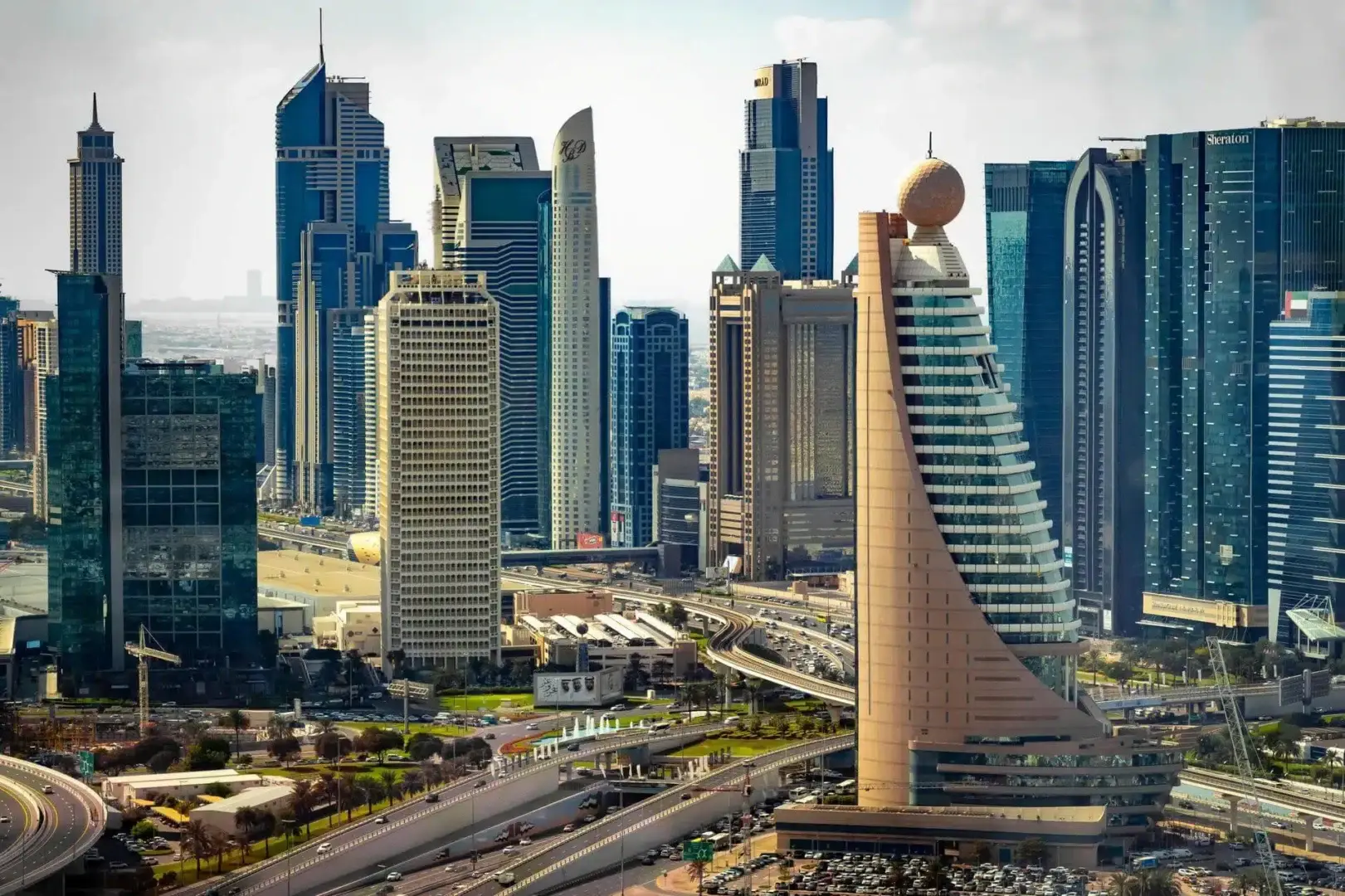 Aerial view of tall towers and modern architecture in Dubai city
