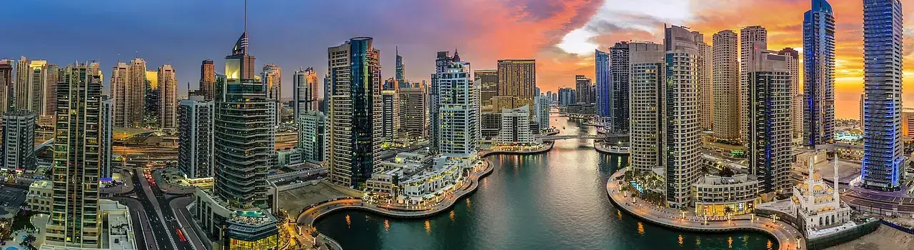 Renting a Home Scenic view of Dubai Marina at sunset, with modern skyscrapers reflecting on the water.