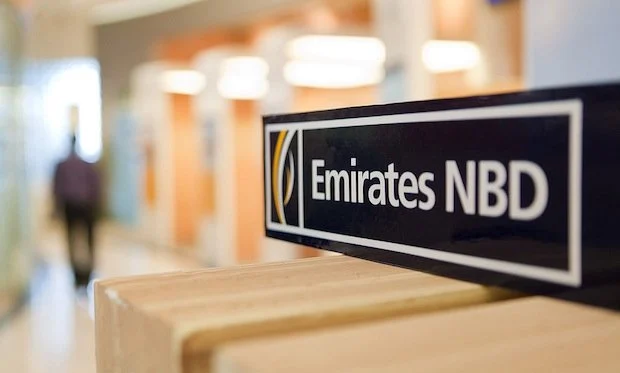 A sign with "Emirates NBD" written on it, and behind it, a hallway is visible