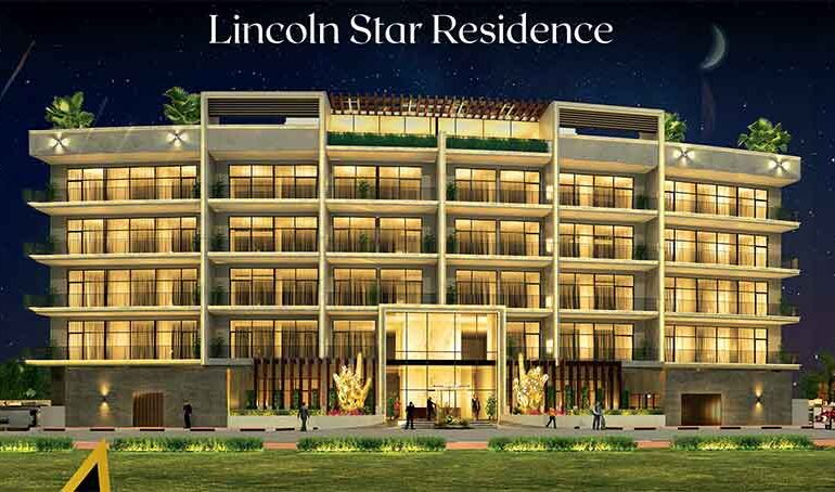 A photo of the front of the Lincoln-Star-Residence complex taken at night with the lights on