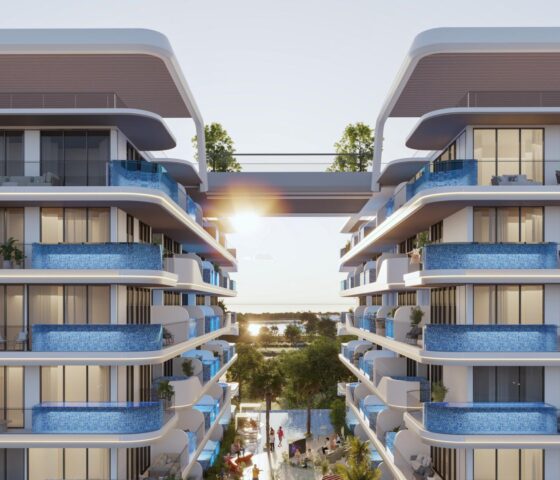 Front view of Samana Ocean Pearl 2 in Dubai, an apartment on top of a mountain or green hill, with a white and blue house. The photo was taken from the front of the apartment.