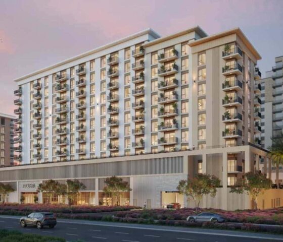 Stylish multi-storey façade with private balconies and lush landscaping at Augusta Town Square in Dubai.