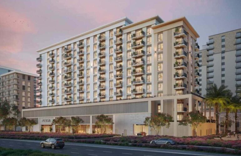 Stylish multi-storey façade with private balconies and lush landscaping at Augusta Town Square in Dubai.