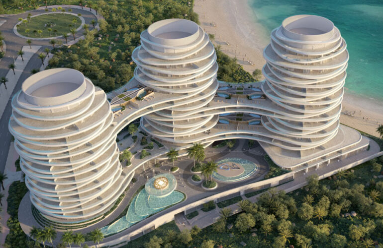 Full aerial masterplan of La Mer Dubai featuring three sculptural ELIE SAAB towers and a central lagoon-style pool.