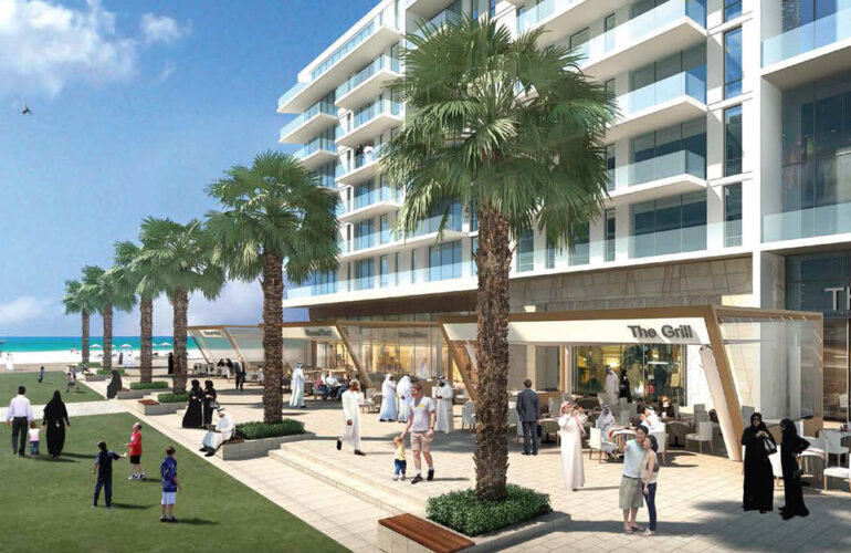 A modern beachfront apartment complex at Mamsha Al Saadiyat Dubai, featuring palm-lined walkways, cafes, and a lively community atmosphere.
