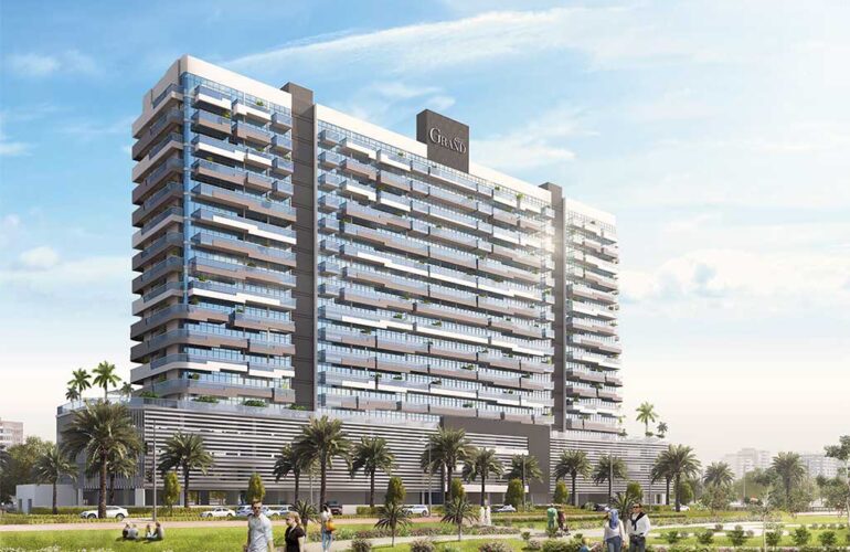 Daytime view of Azizi Grand tower in Dubai with open outdoor space