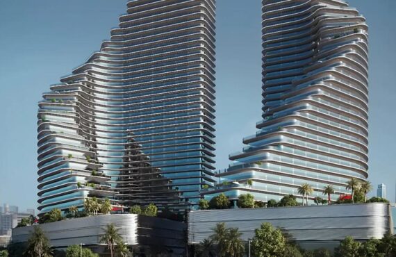 Exterior view of the twin towers of Binghatti Flare in Dubai, showcasing their unique architectural design under a clear sky.