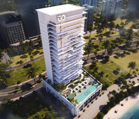 view of Ayaan Heights residential tower with illuminated façade and poolside