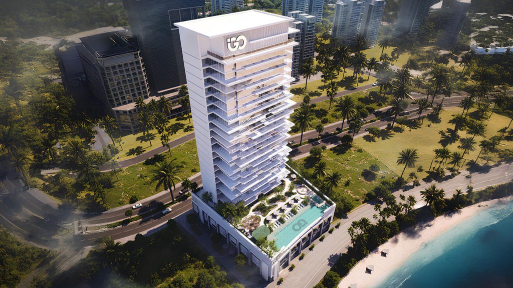 view of Ayaan Heights residential tower with illuminated façade and poolside