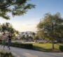 People jogging and walking through the green community park at Selvara.