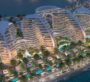 Aerial view of Oystra residences featuring curved architecture and waterfront pool terraces.