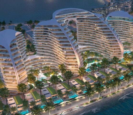 Aerial view of Oystra residences featuring curved architecture and waterfront pool terraces.