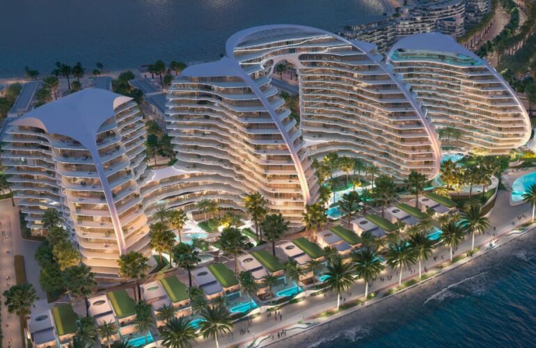 Aerial view of Oystra residences featuring curved architecture and waterfront pool terraces.