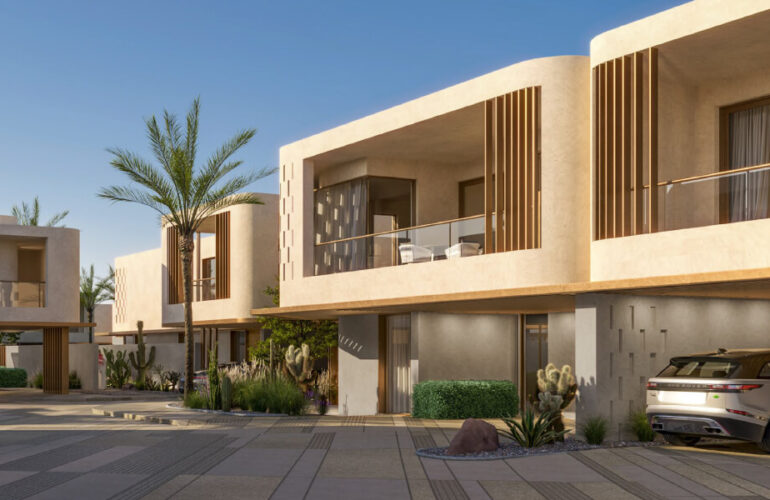 A row of modern villas in the Al Tay Hills community in Dubai, featuring spacious balconies and green surroundings.