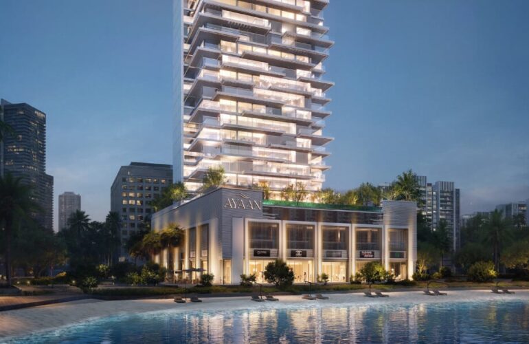 Night view of Ayaan Heights residential tower with illuminated façade and poolside