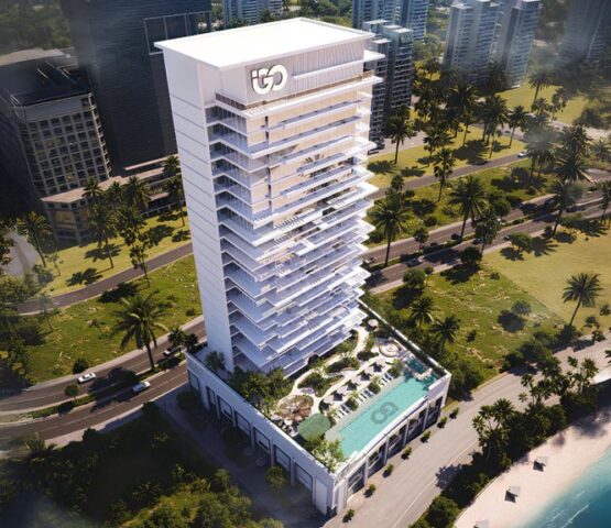 view of Ayaan Heights residential tower with illuminated façade and poolside