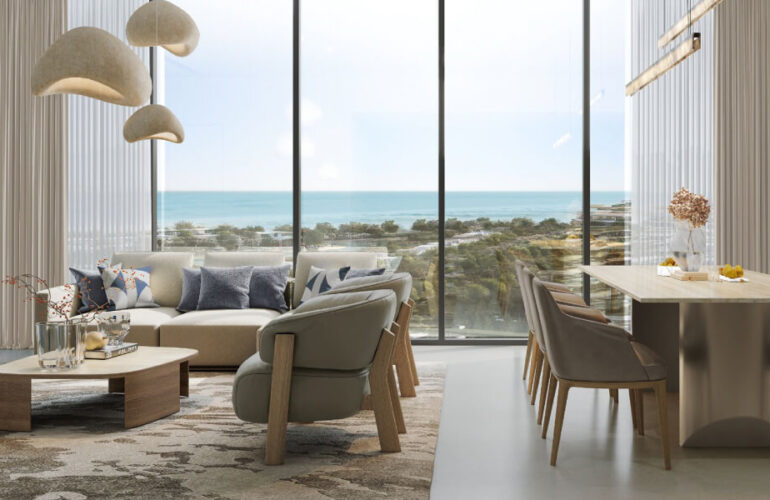 Stylish living room in Bayfront Marina Residences, Dubai, with panoramic floor-to-ceiling windows facing the sea.