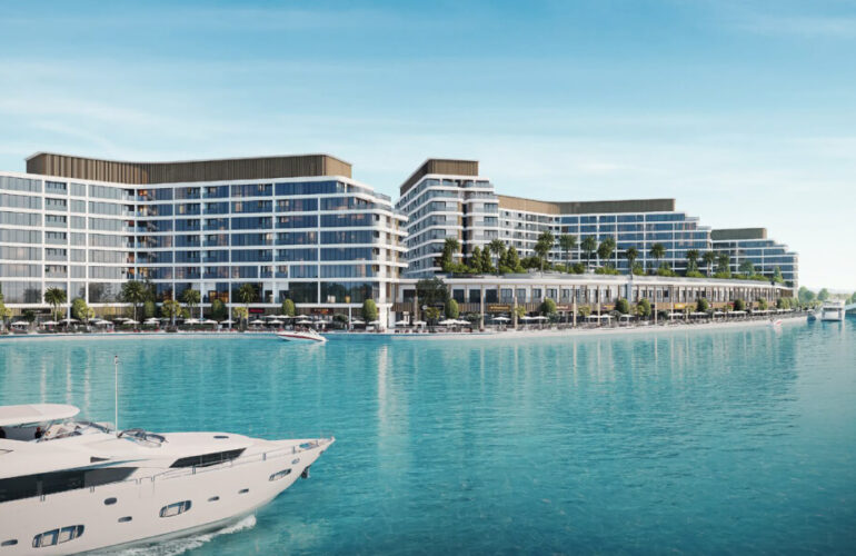 Exterior waterfront view of Bayfront Marina Residences in Dubai, showing luxury modern buildings beside turquoise waters.