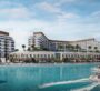 Exterior waterfront view of Bayfront Marina Residences in Dubai, showing luxury modern buildings beside turquoise waters. sobha