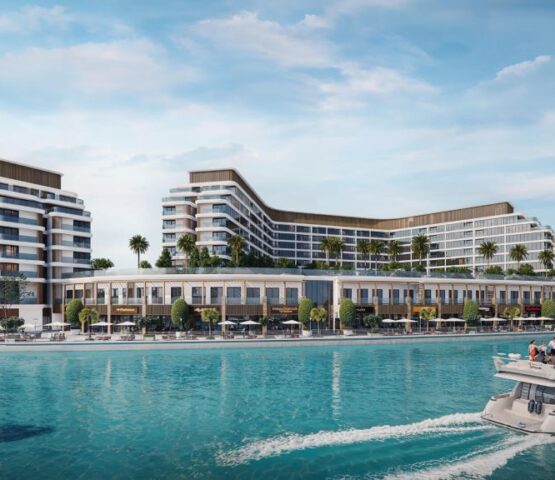 Exterior waterfront view of Bayfront Marina Residences in Dubai, showing luxury modern buildings beside turquoise waters. sobha