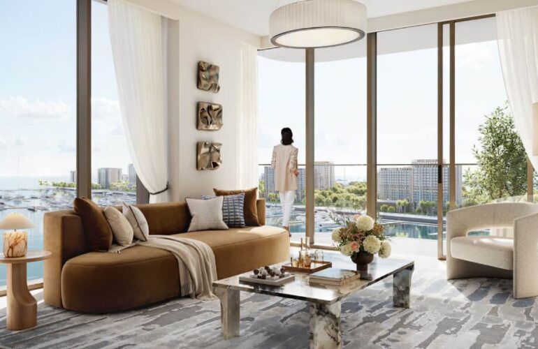 Elegant and sunlit living room in Baystar by Vida, Dubai, offering panoramic views of the waterfront marina.