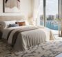 Comfortable bedroom at Baystar by Vida in Dubai, featuring large windows with views of the calm marina waters.
