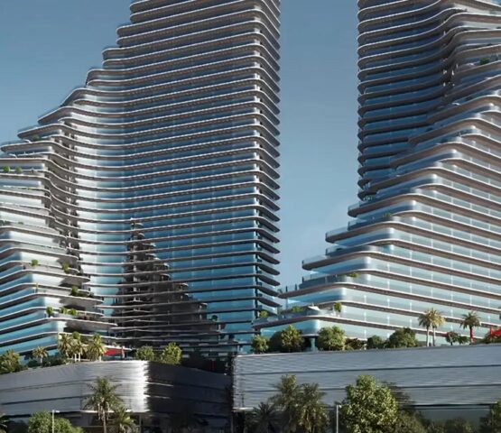 Exterior view of the twin towers of Binghatti Flare in Dubai, showcasing their unique architectural design under a clear sky.