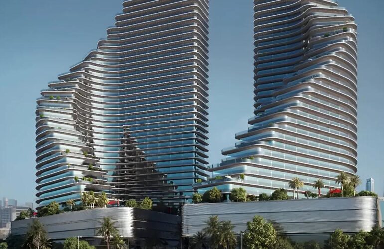 Exterior view of the twin towers of Binghatti Flare in Dubai, showcasing their unique architectural design under a clear sky.