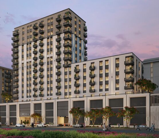 A sleek mid-rise residential tower featuring a modern facade, warm evening lighting, and lush landscaping—offering a premium lifestyle at Odessa by Nshama.