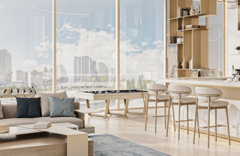 Modern open-plan living and kitchen space in Cove Edition 6, Dubai, filled with natural light through floor-to-ceiling windows.