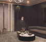 Warm, intimate lounge with dark wood accents and plush seating