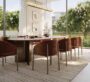 Elegant dining area at Selvara, featuring a contemporary table set and garden views.