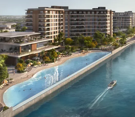 A scenic aerial view of the waterfront residences in Dubai, surrounded by lush greenery.