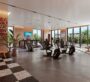 Modern gym facility inside Hyde Residence with workout equipment and mirrors