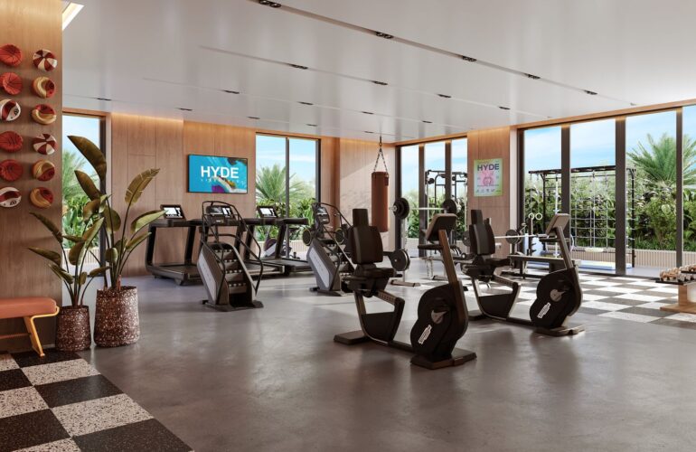Modern gym facility inside Hyde Residence with workout equipment and mirrors
