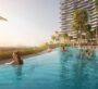 Infinity pool at Laguna Residence in Dubai with a view of the city. People are swimming in the pool, which is located at a high elevation. The apartment is seen from two angles in this photo.