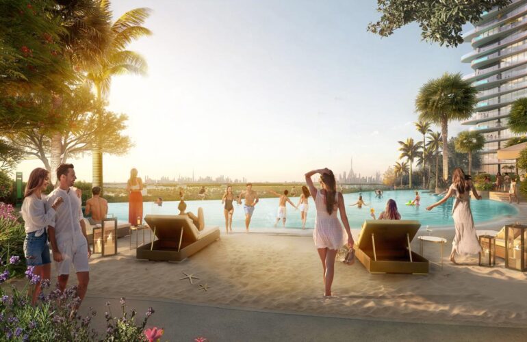 Pool area at Laguna Residence in Dubai, resembling a beach with sand around the pool. People are relaxing by the pool like at the beach, and palm trees surround the area.