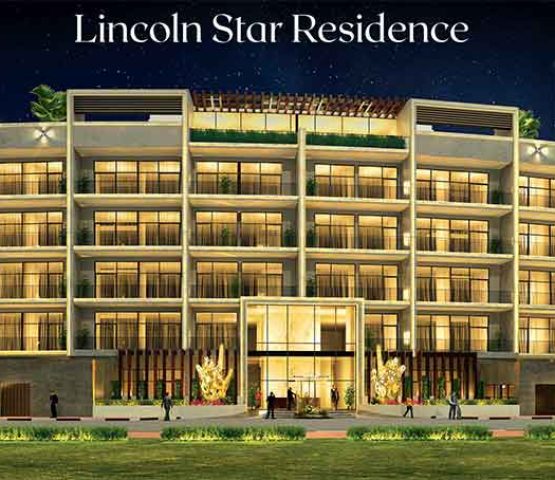 A photo of the front of the Lincoln-Star-Residence complex taken at night with the lights on