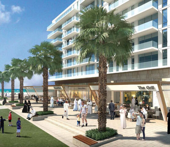 A modern beachfront apartment complex at Mamsha Al Saadiyat Dubai, featuring palm-lined walkways, cafes, and a lively community atmosphere.