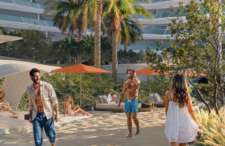 People enjoying a walk along Oystra’s luxury beachfront lined with palm trees and amenities.