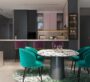 Contemporary dining area with teal chairs and modern kitchen at MBL Signature Dubai
