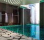 Indoor pool with luxurious design and cityscape view at MBL Signature Dubai