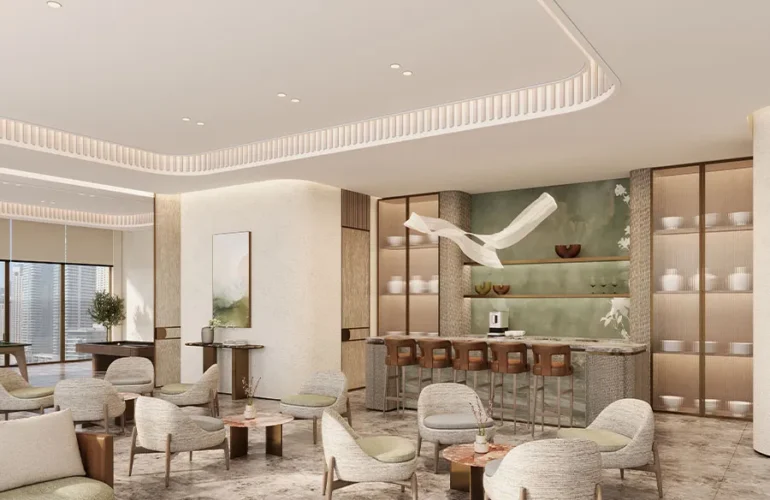 Marriott-Residences-at-JLT- A modern lounge with neutral-toned furniture, a sleek bar area, and minimalist decor, creating a calm and contemporary atmosphere