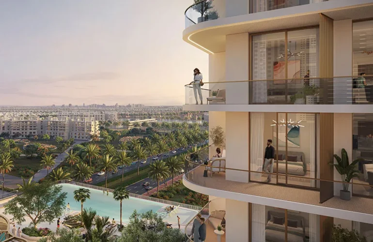 Marriott-Residences-at-JLT-balcony A balcony with two people standing on it, offering a view of greenery with a lagoon in the space.