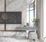 Mayfair Gardens Dubai – TV lounge with marble wall and cozy furniture