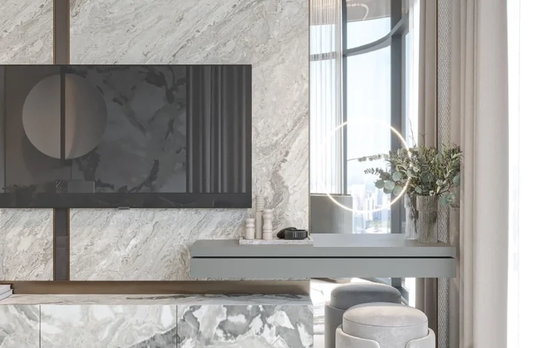 Mayfair Gardens Dubai – TV lounge with marble wall and cozy furniture