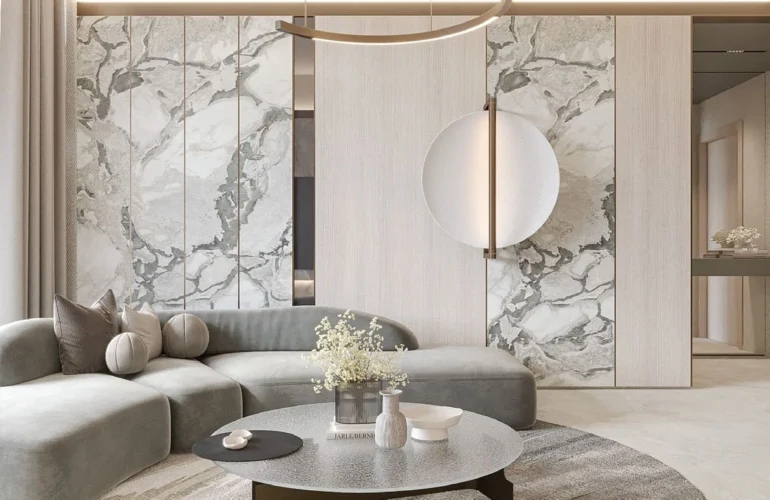 Mayfair Gardens Dubai – Living room with circular chandelier and marble wall