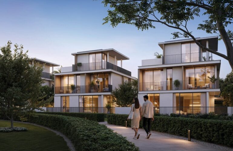 Modern luxury villas at Selvara at dusk, with warm lighting and landscaped pathways.