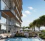 Outdoor pool and terrace area surrounded by trees and city views at Cove Boulevard