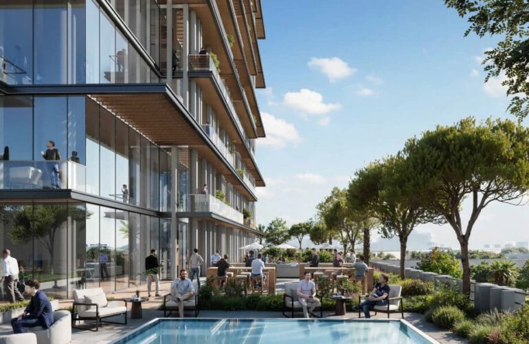 Outdoor pool and terrace area surrounded by trees and city views at Cove Boulevard